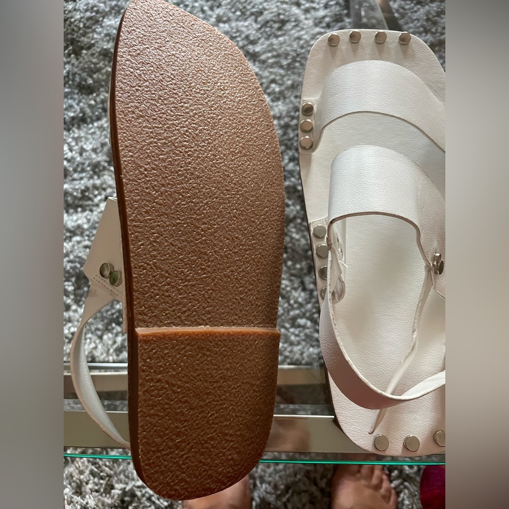 handcrafted fashion-forward white leather sandal with silver tone stud detail..